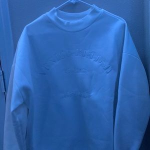 White crew neck sweater.